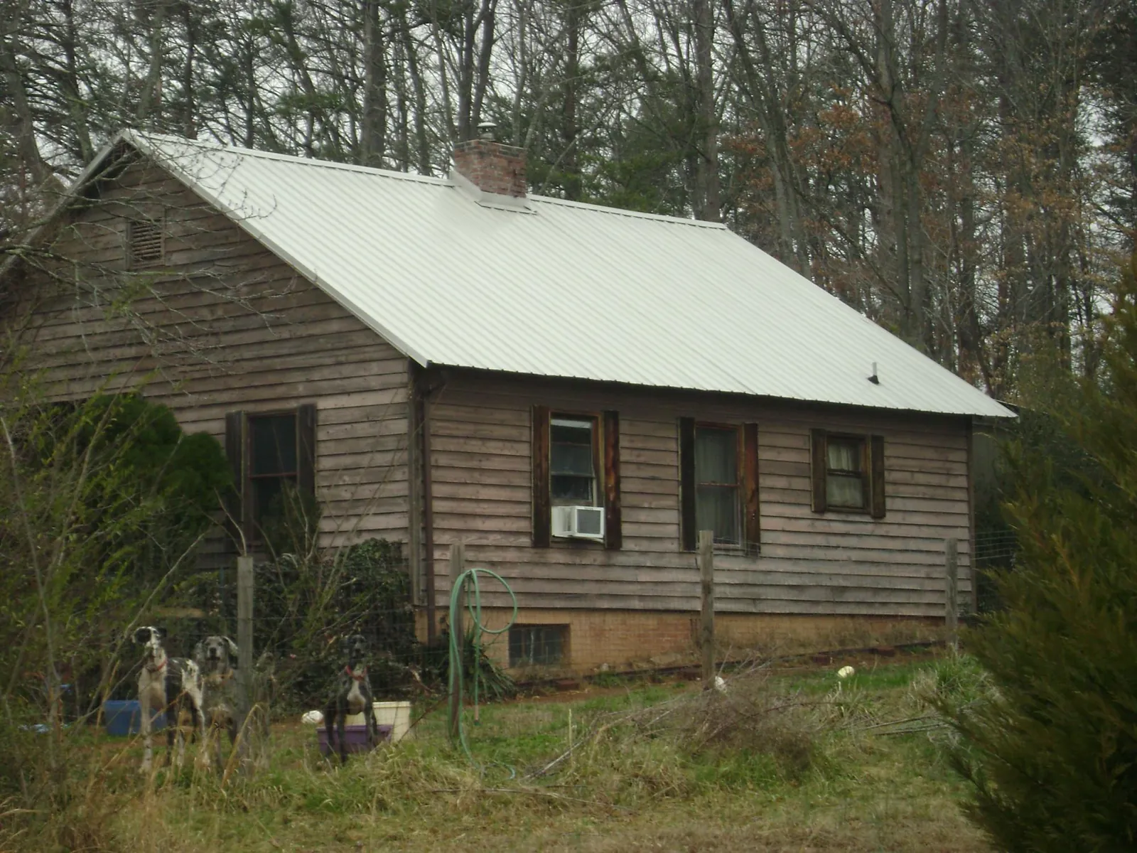 White metal roof on an old wood sided farmhouse, from a Metal Roof Installation job in Fairfield